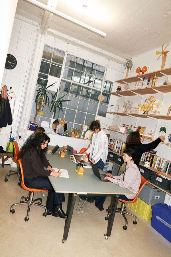 Team gathered around the studio table
