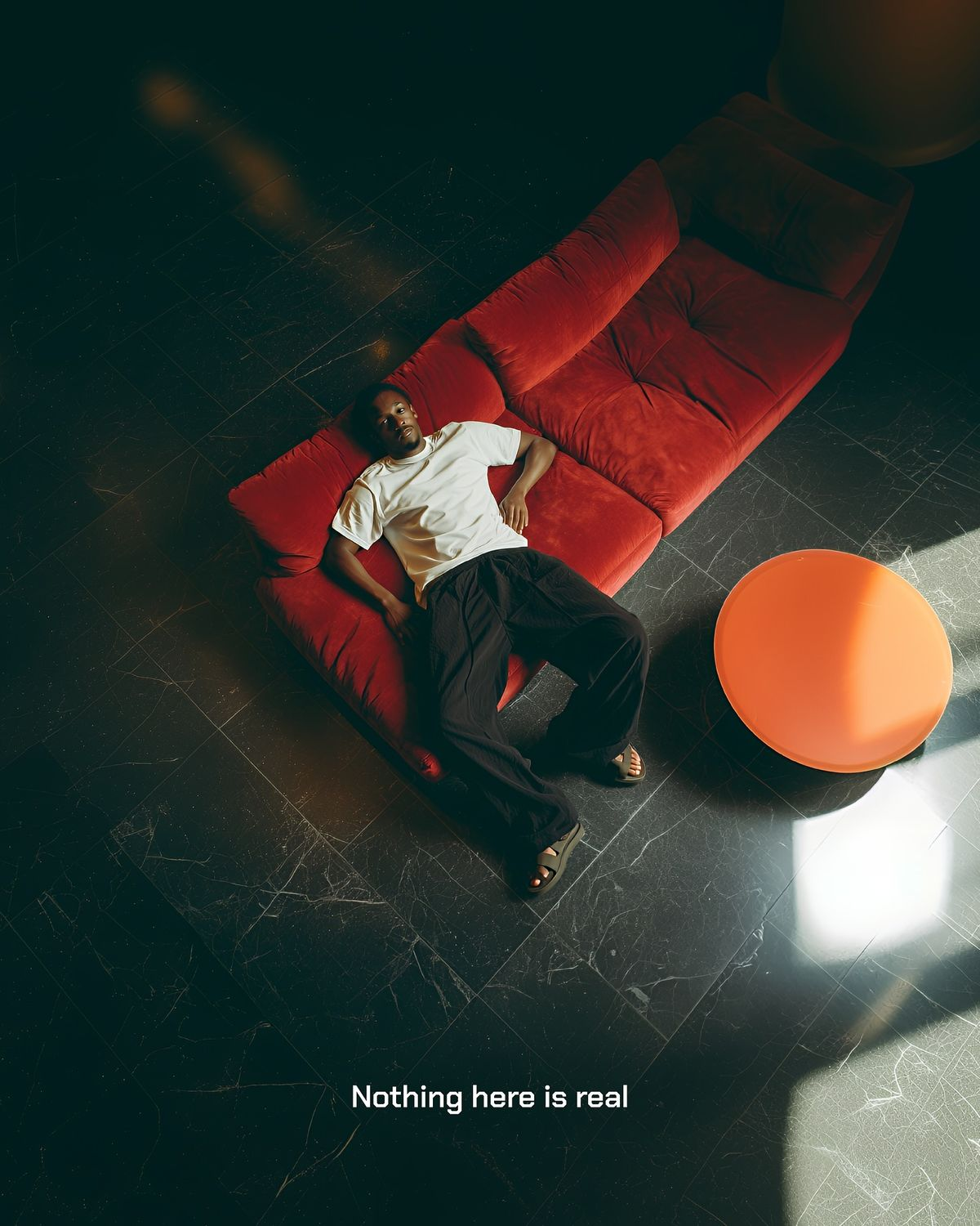 Editorial scene with a figure on a red couch